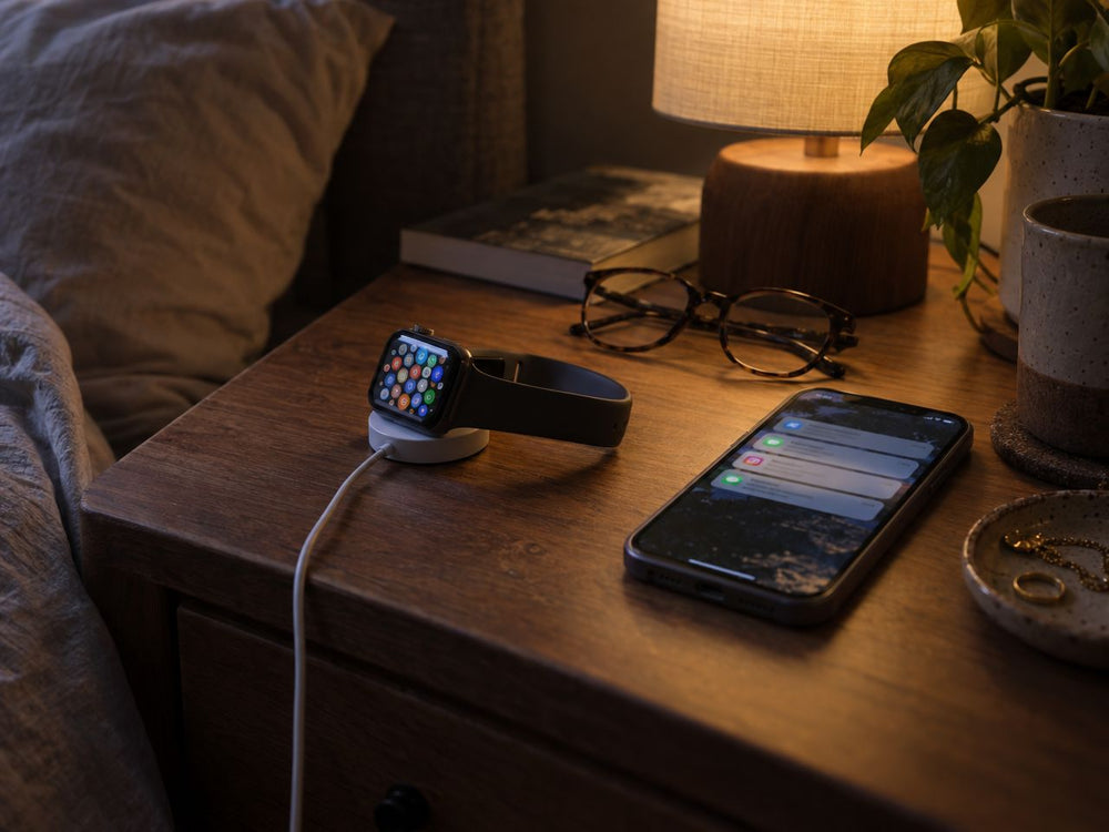 Illustration: a typical smartwatch charging on a nightstand with tiny icons